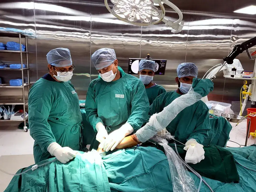 Dr Jadhav and surgical team performing an arthroscopic procedure in theatre